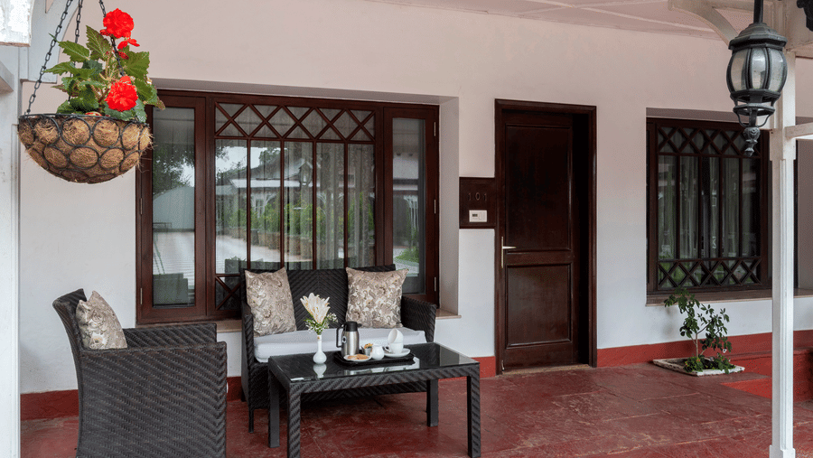 Outside seating area with a three seater couch at The Claridges Nabha Residence