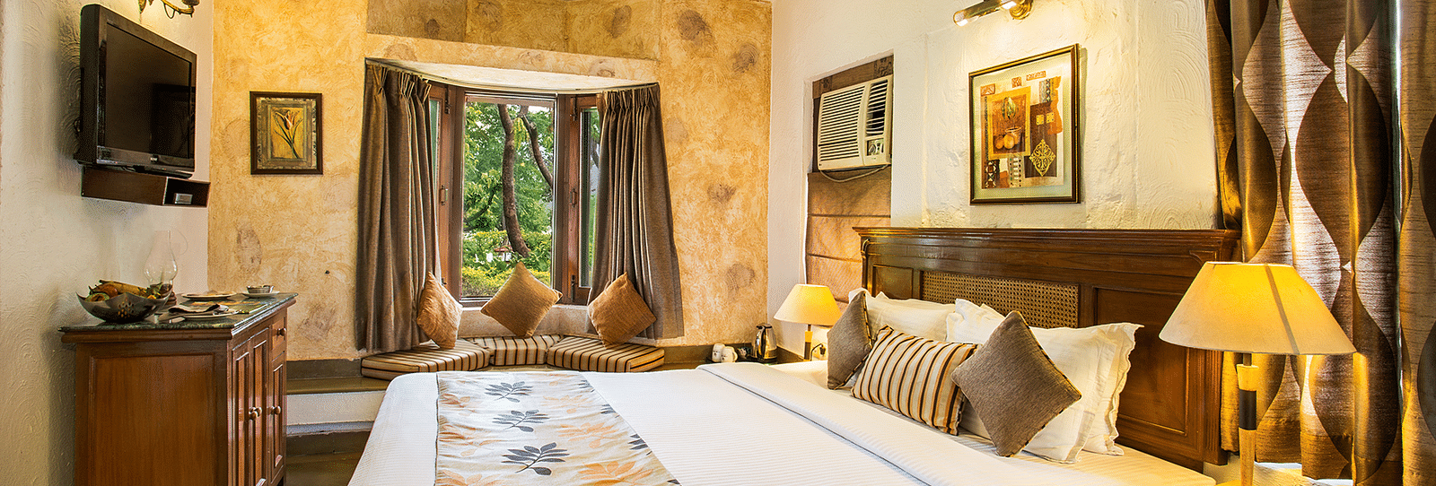 An image of a bedroom with a fan hanging from the ceiling at Leisure Hotels.
