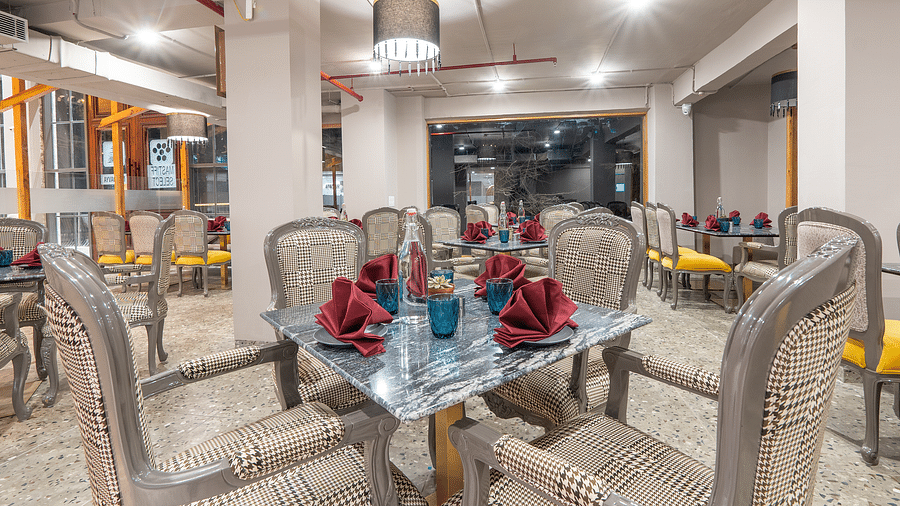 an image of a dining space with tables and chairs