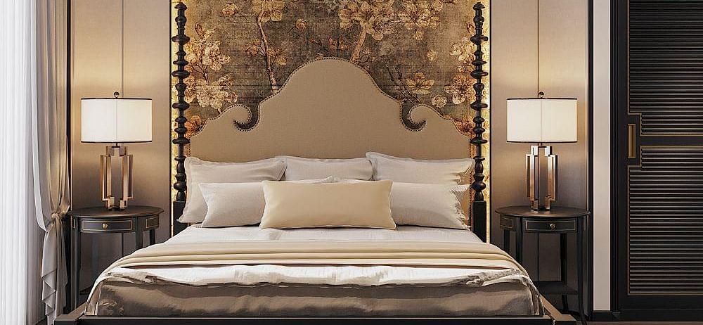 Front view of a well-made bed with cushions, a ceiling fan, and two bedside tables with lamps at The Evren, Vagator.