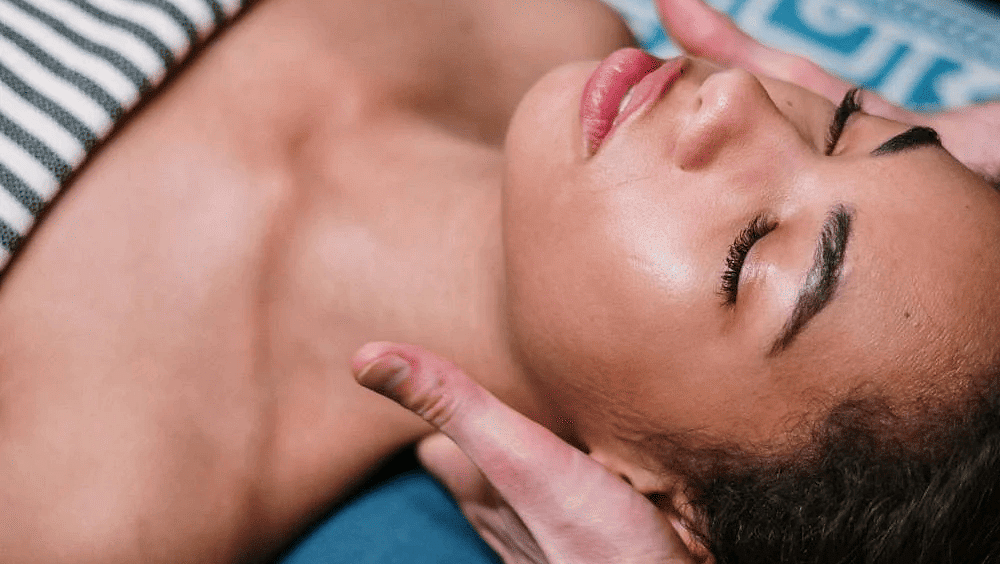 A woman getting her neck massage in a spa.