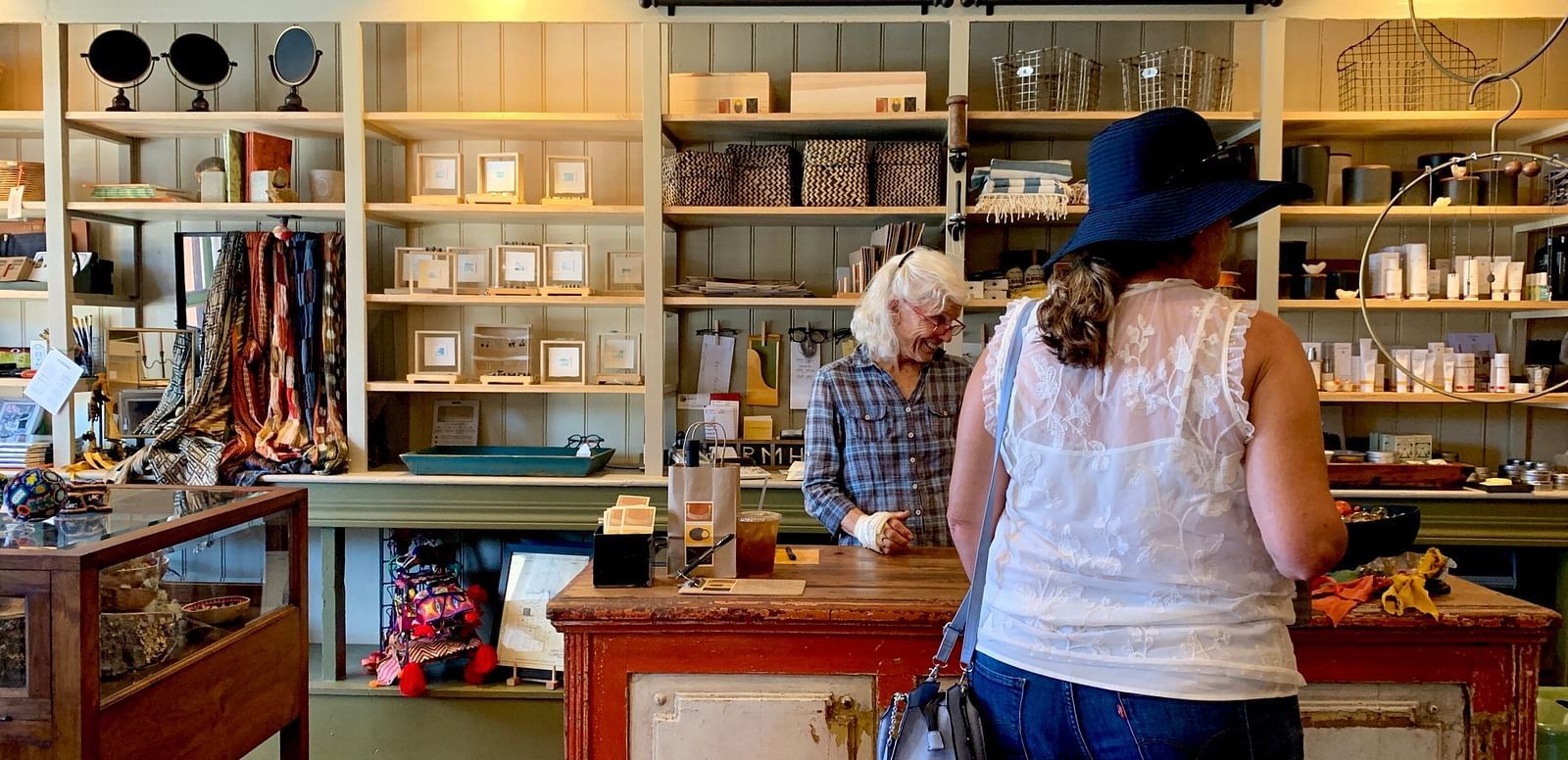An image of a souvenir shop where one person is behind the counter.