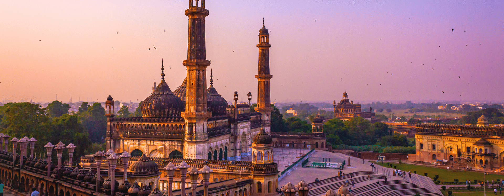 Banner for New Year Extravaganza featuring a historic monument in Lucknow 