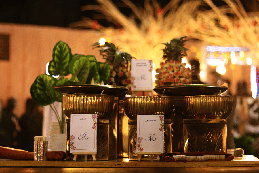 Decorated food station at The Sonnet with arranged dishes, greenery, and warm lighting.