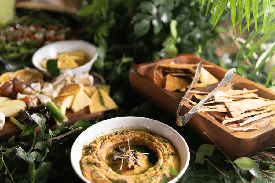 Rustic food spread with breads, dips, and leafy décor arranged on a table at The Sonnet.