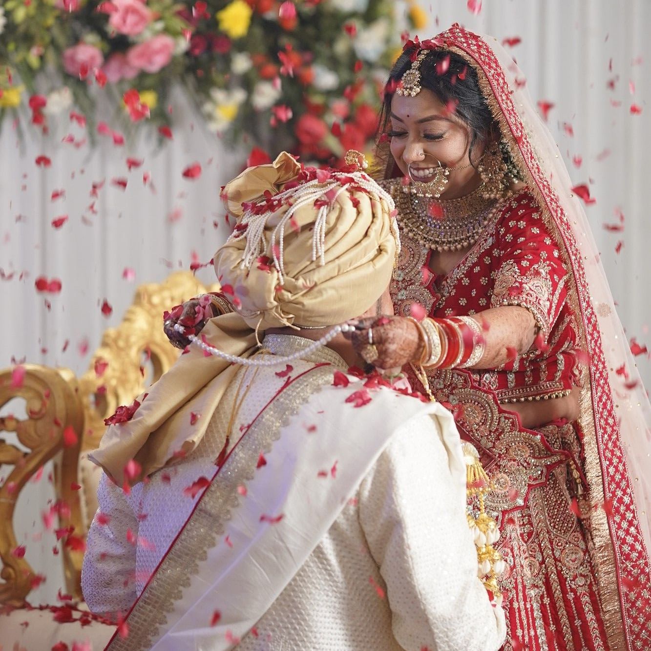 A hindu couple married and the bride is putting garland into the groom's neck at The Zion, Shimla