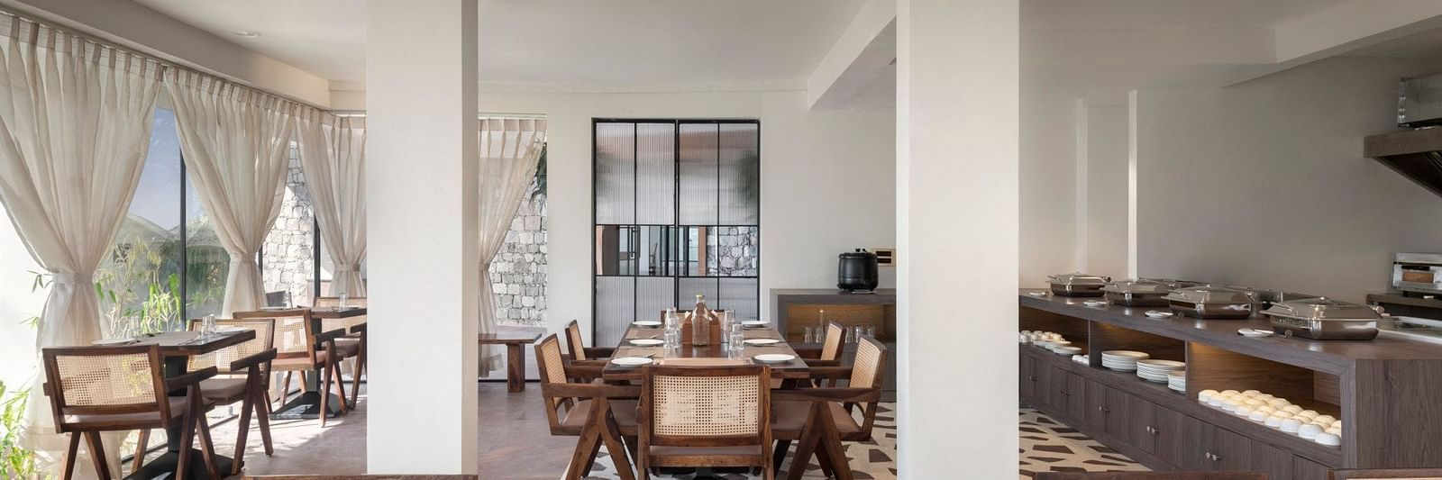 An interior view of a restaurant with wooden chairs and tables - The Samai, Bhimtal