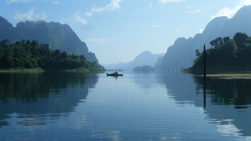 A lake reflecting the sky and distant mountains.