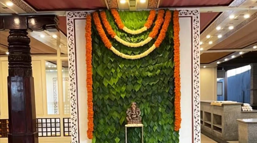 image of a wedding ceremony with all the glamour being set up in the tambulam banquet hall at hoysala village resort in hassan