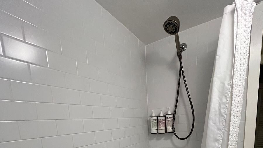 a bathroom at casa morada with a curtained bathtub and a shower.