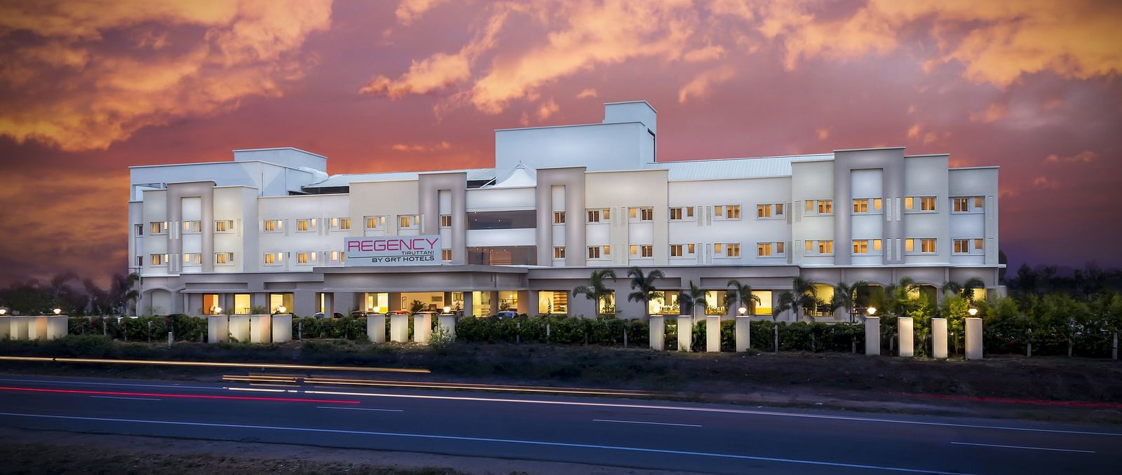 Facade image of Regency Tiruttani by GRT Hotels at dusk.