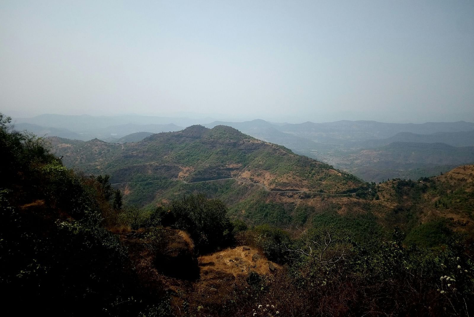 Scenic view featuring layers of hills under a clear sky.