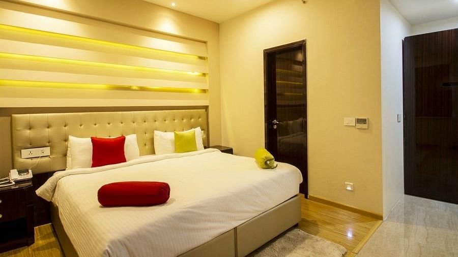 The room of the suite with bed and pillows and blosters on in at Art Boutique Hotel, Hyderabad