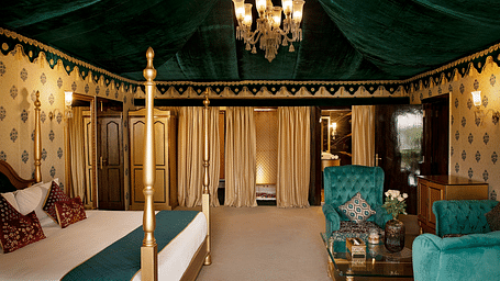 Side view of a room with a bed and a seating area in front at Rajasthali Resort & Spa Jaipur.