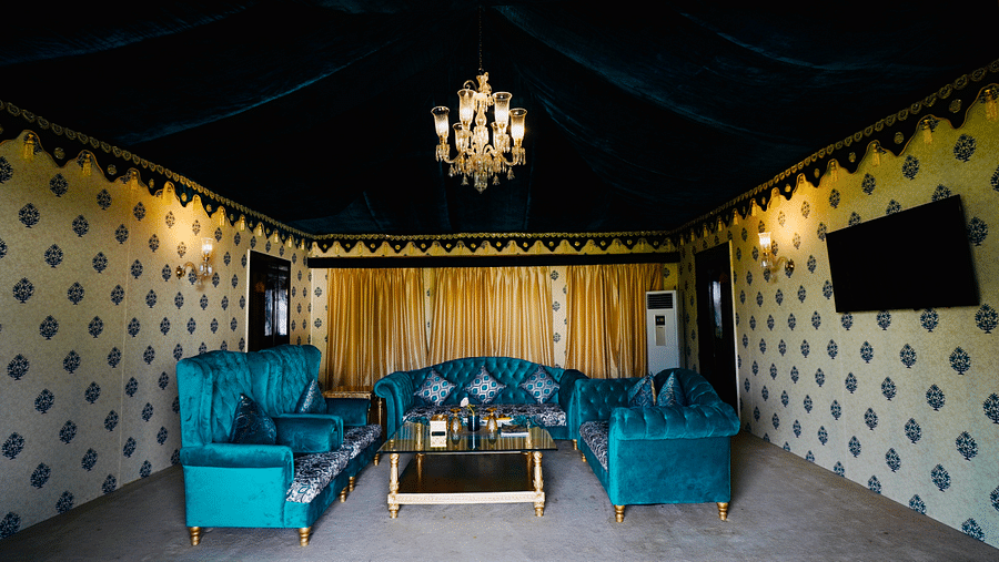 Image of a room with a seating area and a chandelier hanging from the wall at Rajasthali Resort & Spa Jaipur.