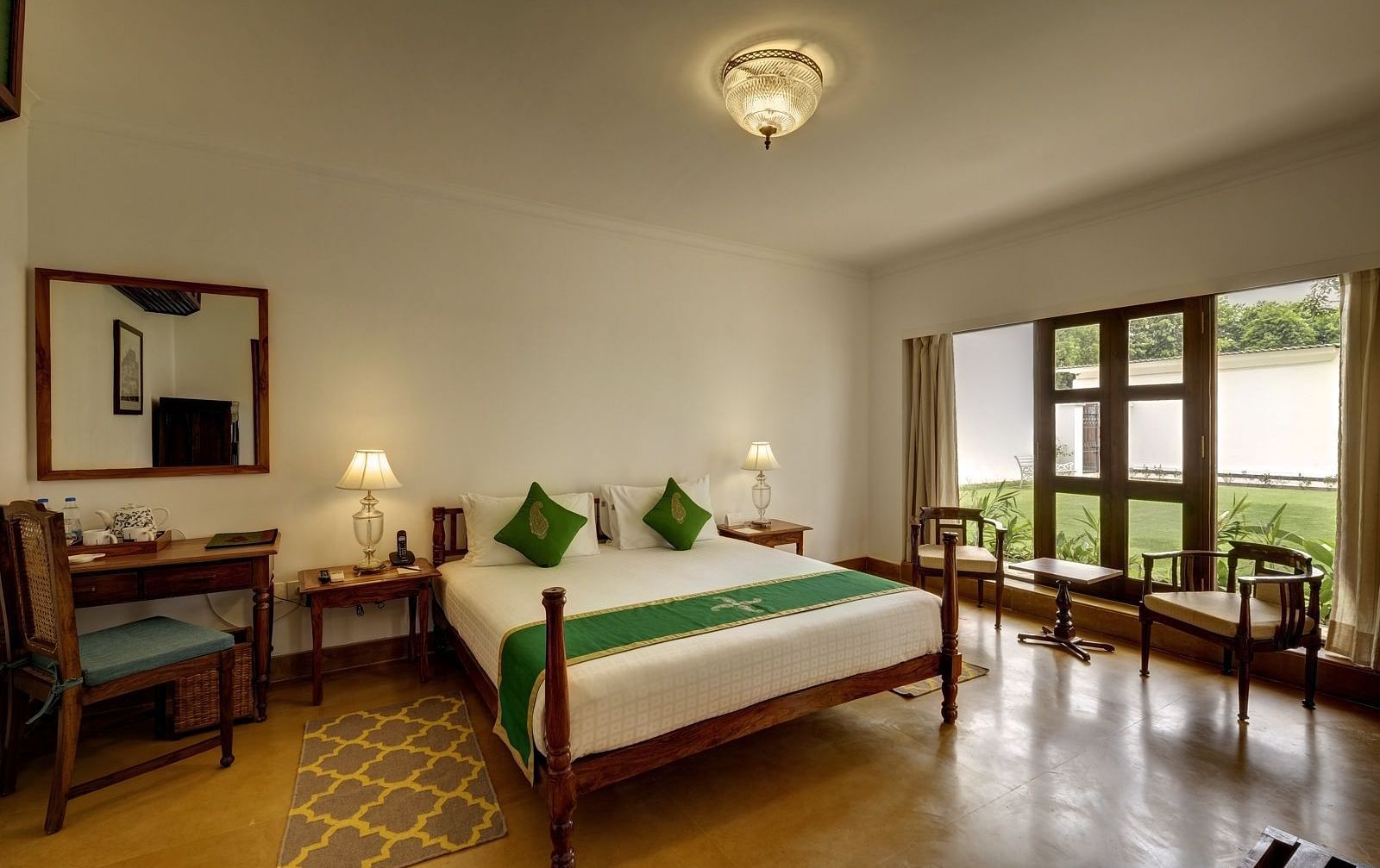 Residency Room with a double bed and a work desk and chair at Saraca Hotel, Lucknow