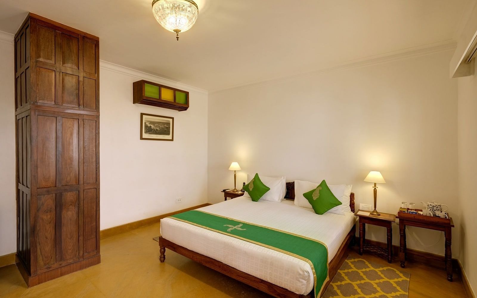 Residency Room with a double bed and a wardrobe at Saraca Hotel, Lucknow