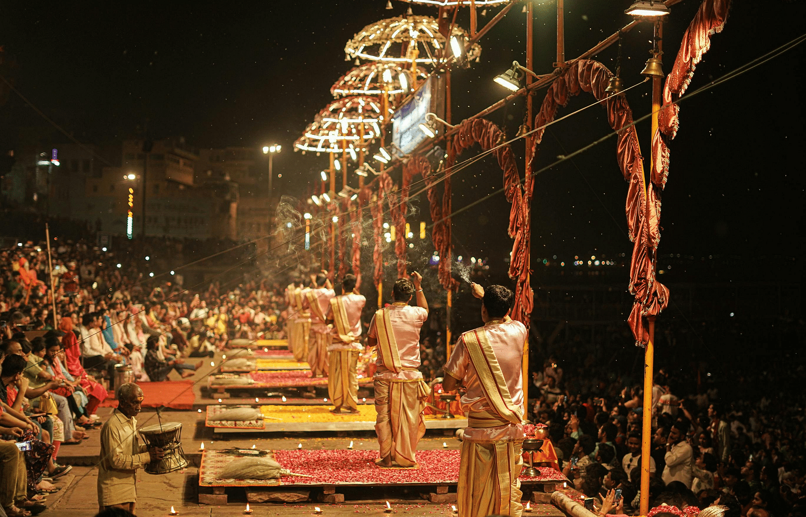 A nighttime scene of the Ganga Aarti, filled with spectators gathered to experience the enchanting ceremony.