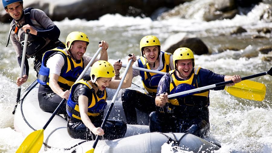 a group of people white water rafting