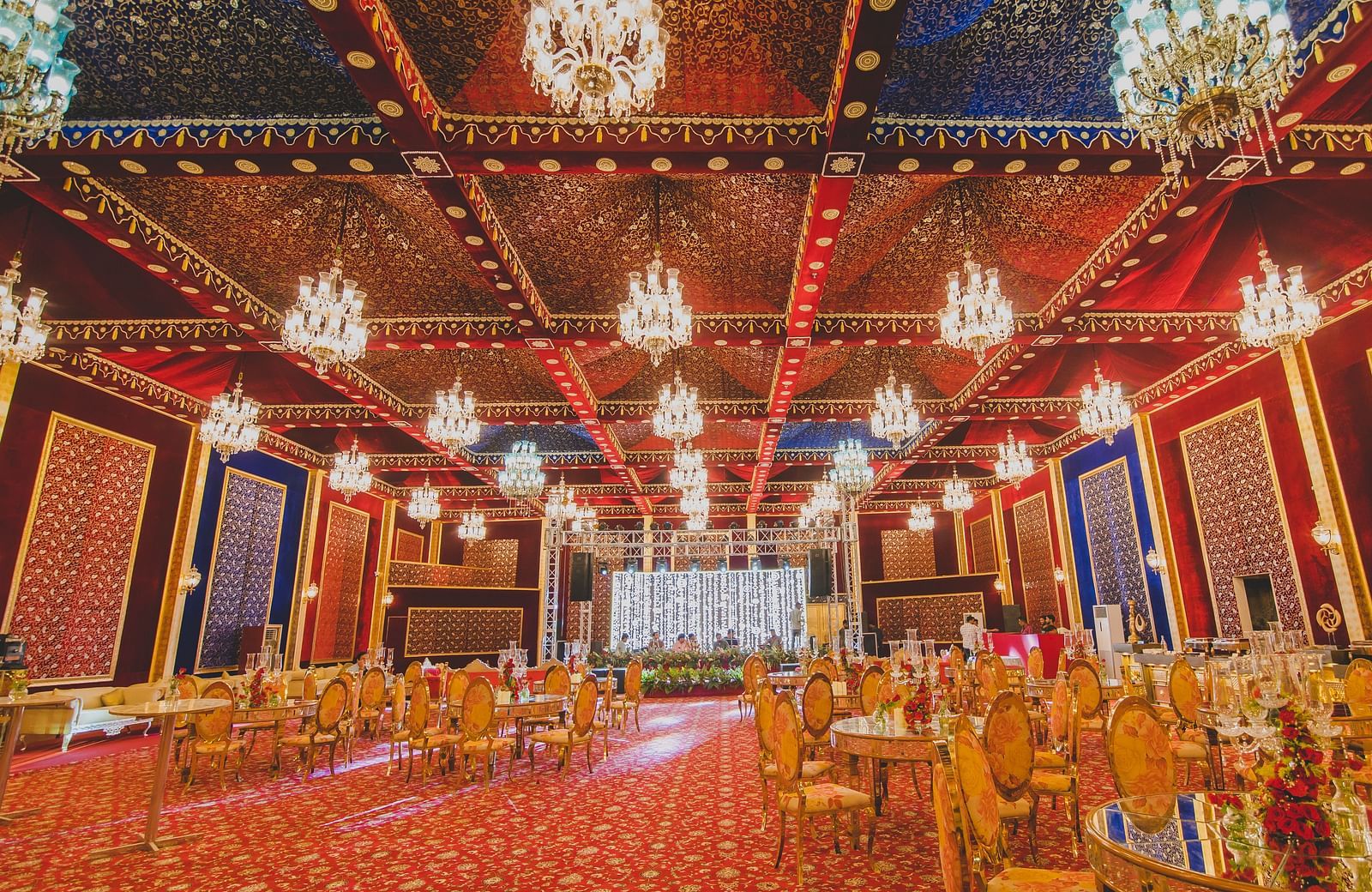Image of Swarn Mahal with chairs and tables and chandeliers hanging from the ceiling at Rajasthali Resort & Spa Jaipur.