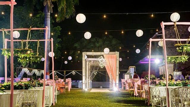 alt-text Event space with paper lanterns and fairy lights at night.