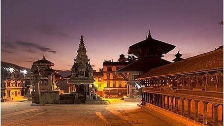 An overview of Bhaktapur Durbar Square in the night with the lights on during the twilight sky