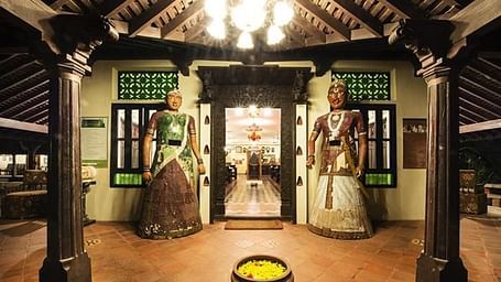 Entrance to Indeco Hotels Swamimalai with two large statues on the side