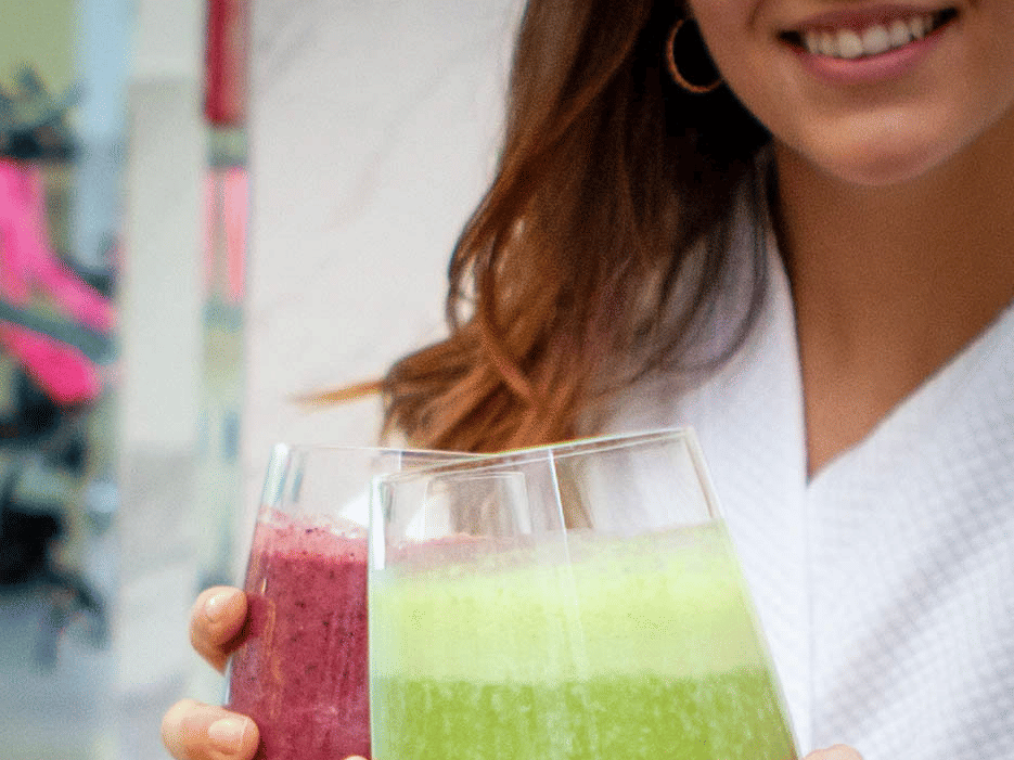 2 individuals clinking glasses with beverages at YO1 Longevity & Health Resorts