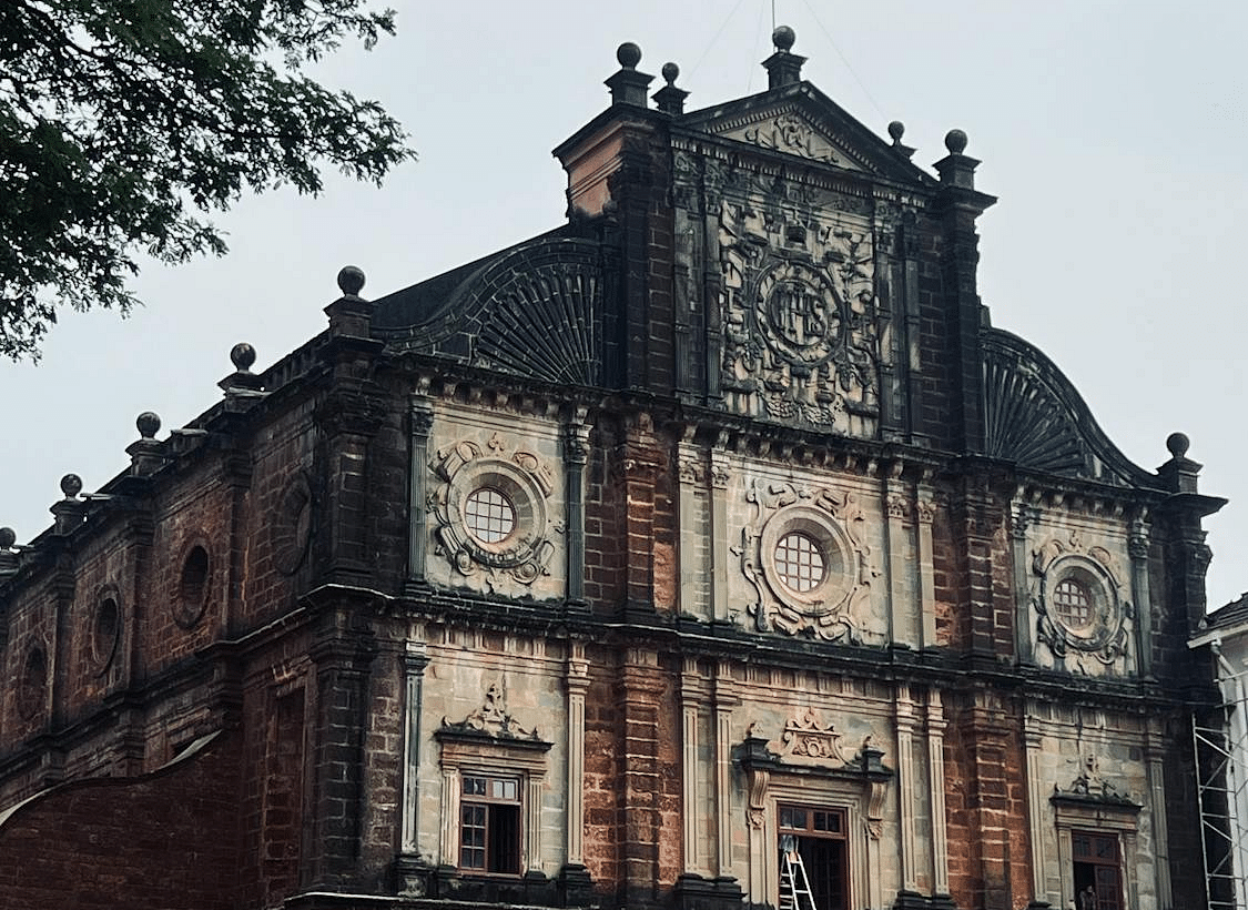 A grand, historic church with an intricately designed stone facade, standing against a cloudy sky.