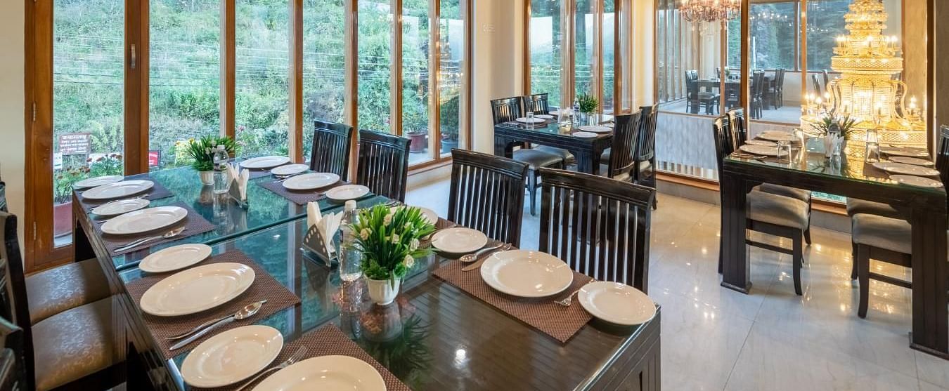 Image of a seating arrangements with tables and chairs, likely designed for both casual and formal dining.