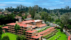 A view of The Carlton located amidst lush green forests and a clear sky - The Carlton, Kodaikanal