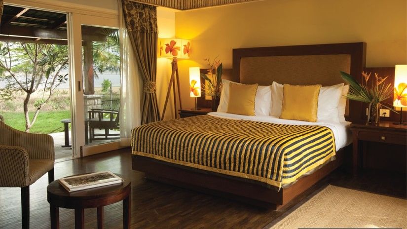 An overview of a room at The Serai Kabini with side tables and lamps 