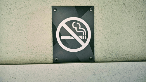 An image showing a no smoking sign mounted on a wall