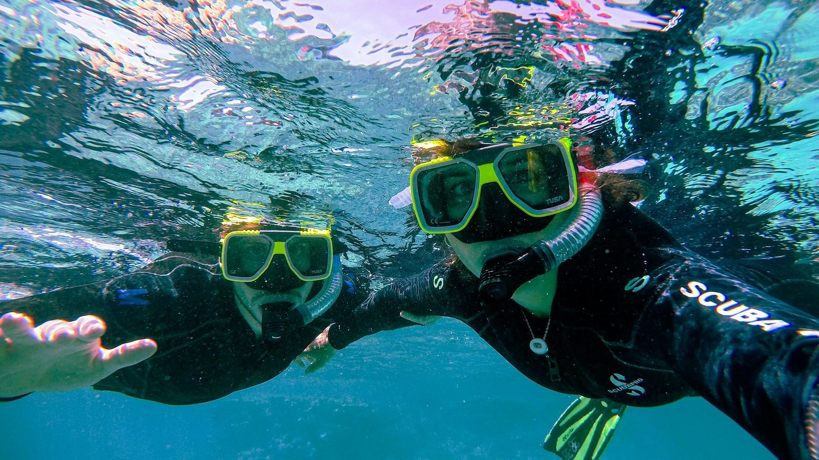 A scuba diver exploring the vibrant coral reef of the Great Barrier Reef, surrounded by colorful fish and marine life.