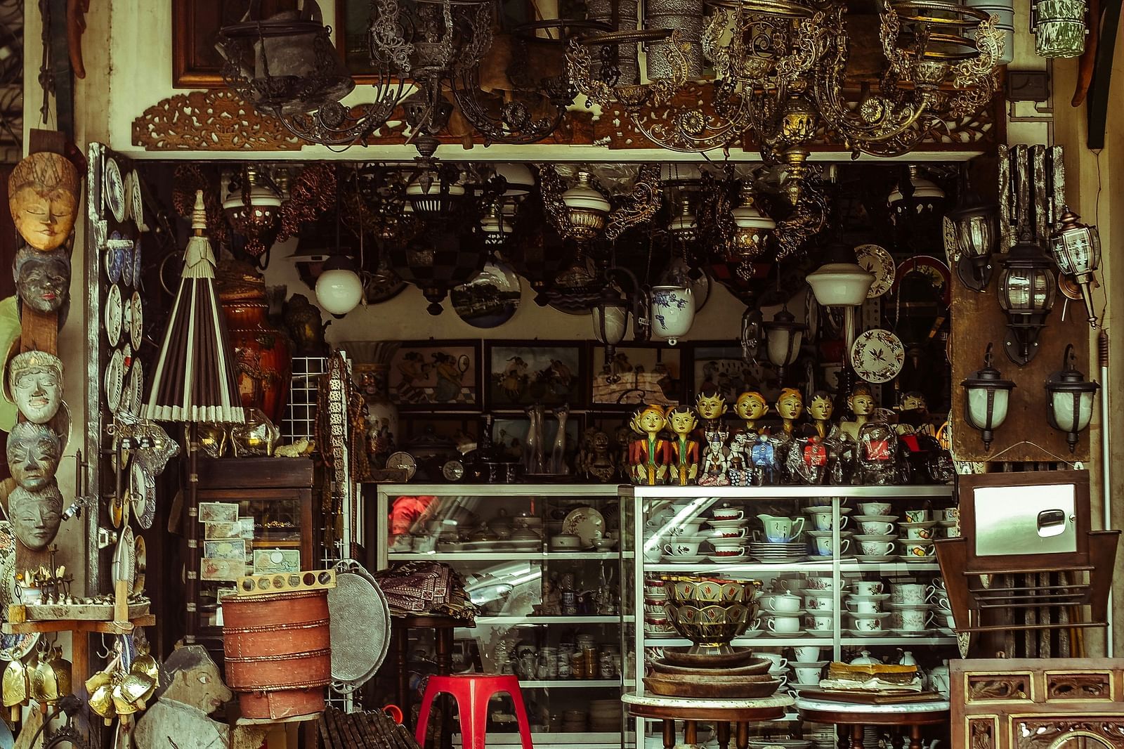 An overview of an antique shop with different items on display for sale.