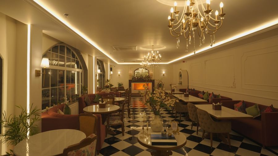 Wide-angle view of a grand dining space with elegant lighting and classic interiors - Mayfair Cafe & Suites, Dalhousie
