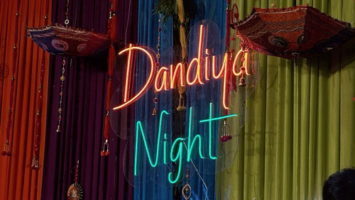 Entrance of the Dandiya Night venue illuminated with decorative lights.