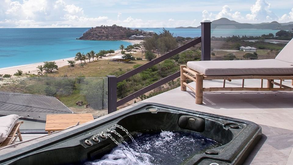 Scenic view of the expansive beach stitched to the skyline, featuring a functioning rectangular jacuzzi and lounge area 