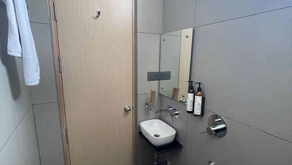 Clean and modern shower area with sleek design at Hotel Kyzen HiTech City – Your Zenly Stay