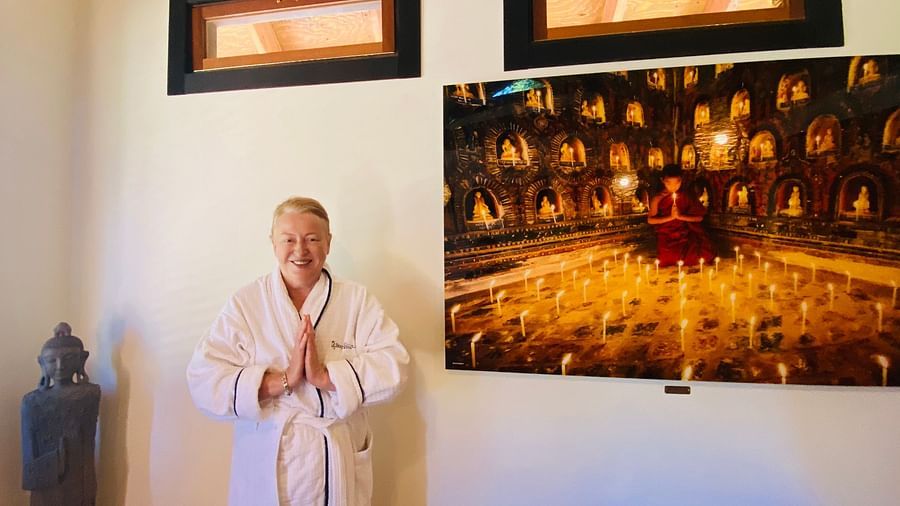 A guest in white robes posing for the camera in the spa at Brewery Gulch Inn & Spa