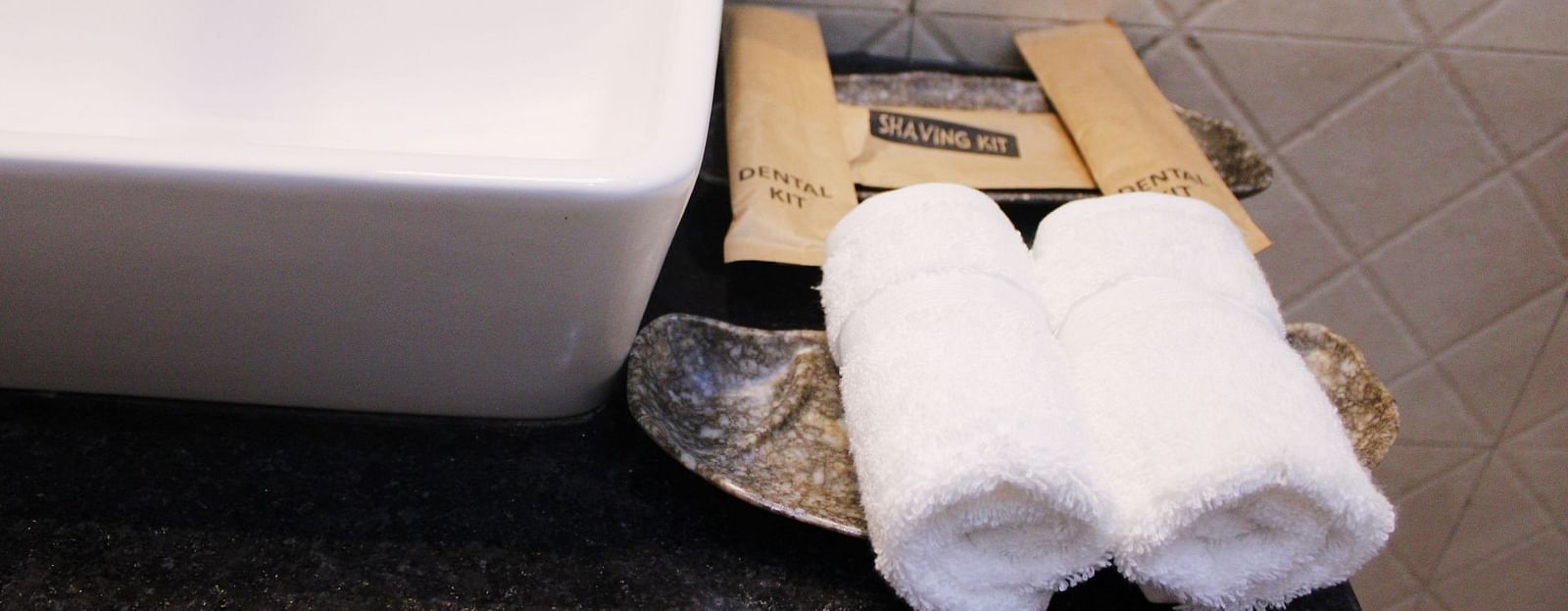 Toiletries placed next to a sink of a Deluxe Cottage Room at Royale Amata - By the Beach.