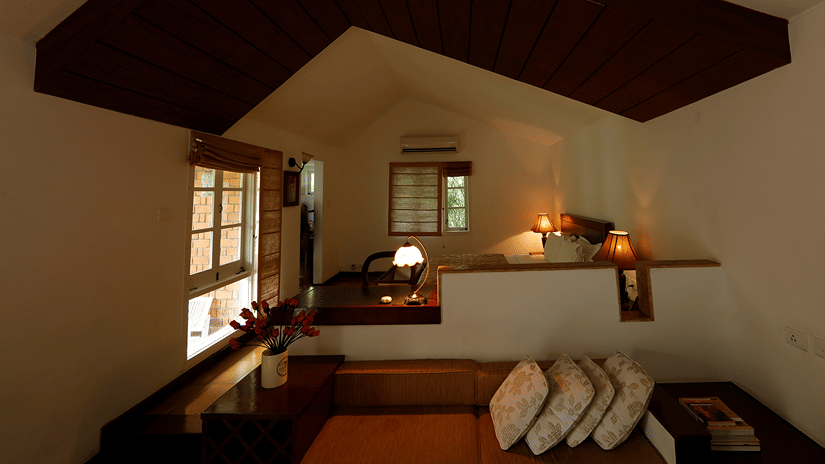 Overhead view of a cosy hotel room with wooden accents- Amanvana Resort And Spa, Resorts in Coorg