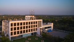 Pride Biznotel Manjusar - facade of our hotel with lawn in front
