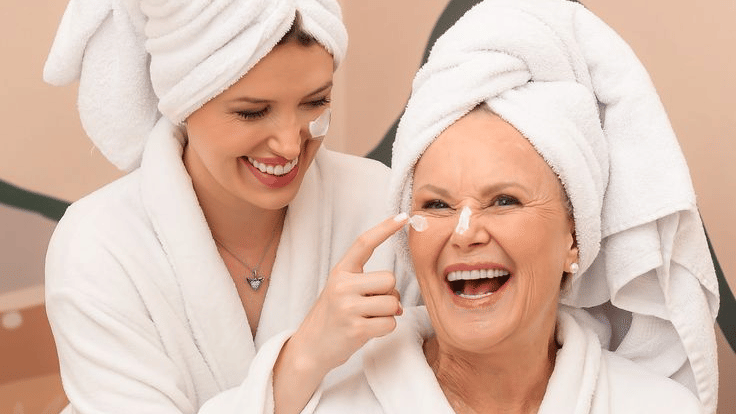Mother and daughter enjoying a relaxing wellness retreat experience at YO1 Longevity & Health Resorts while wearing white spa robes and towels in a calming spa setting.