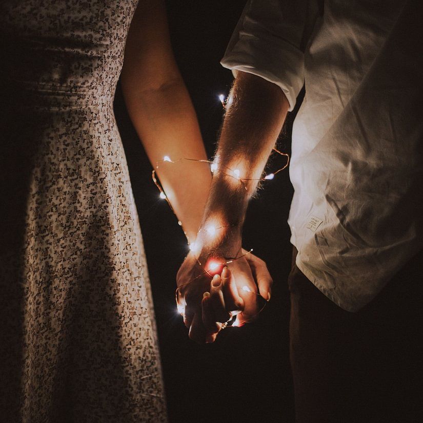 Couple's hands wrapped in fairytale