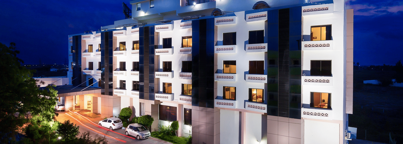 The exterior facade of a hotel building illuminated by warm lights - Regency Tuticorin by GRT Hotels, Best Hotel in Tuticorin
