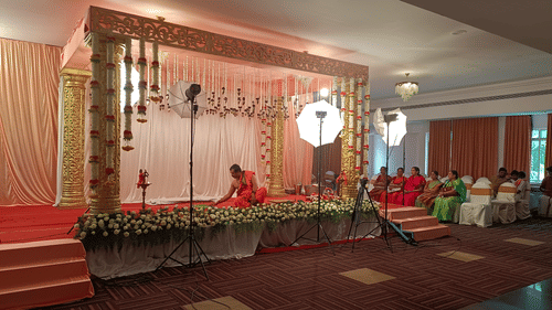 A decorated indoor stage with flowers and lights at the best resort in Bangalore | Ramanashree California Resort