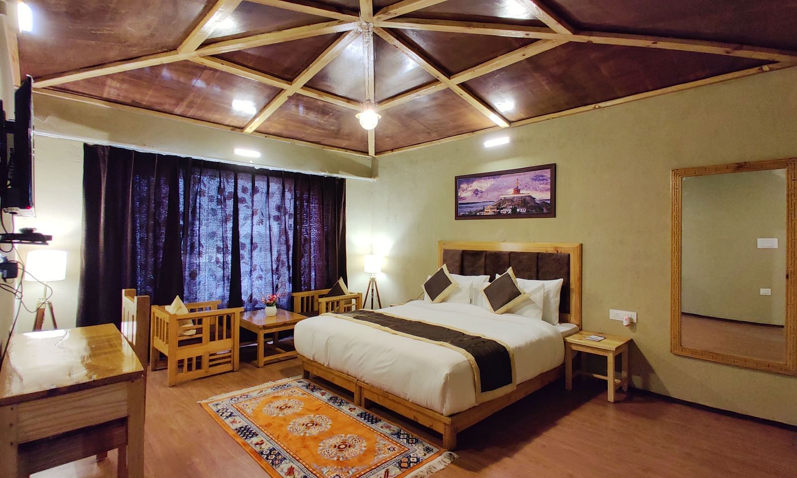 Premium Cottage at White Sands Resort, Ladakh, with a focus on the king size bed, curtains, and wooden furniture.