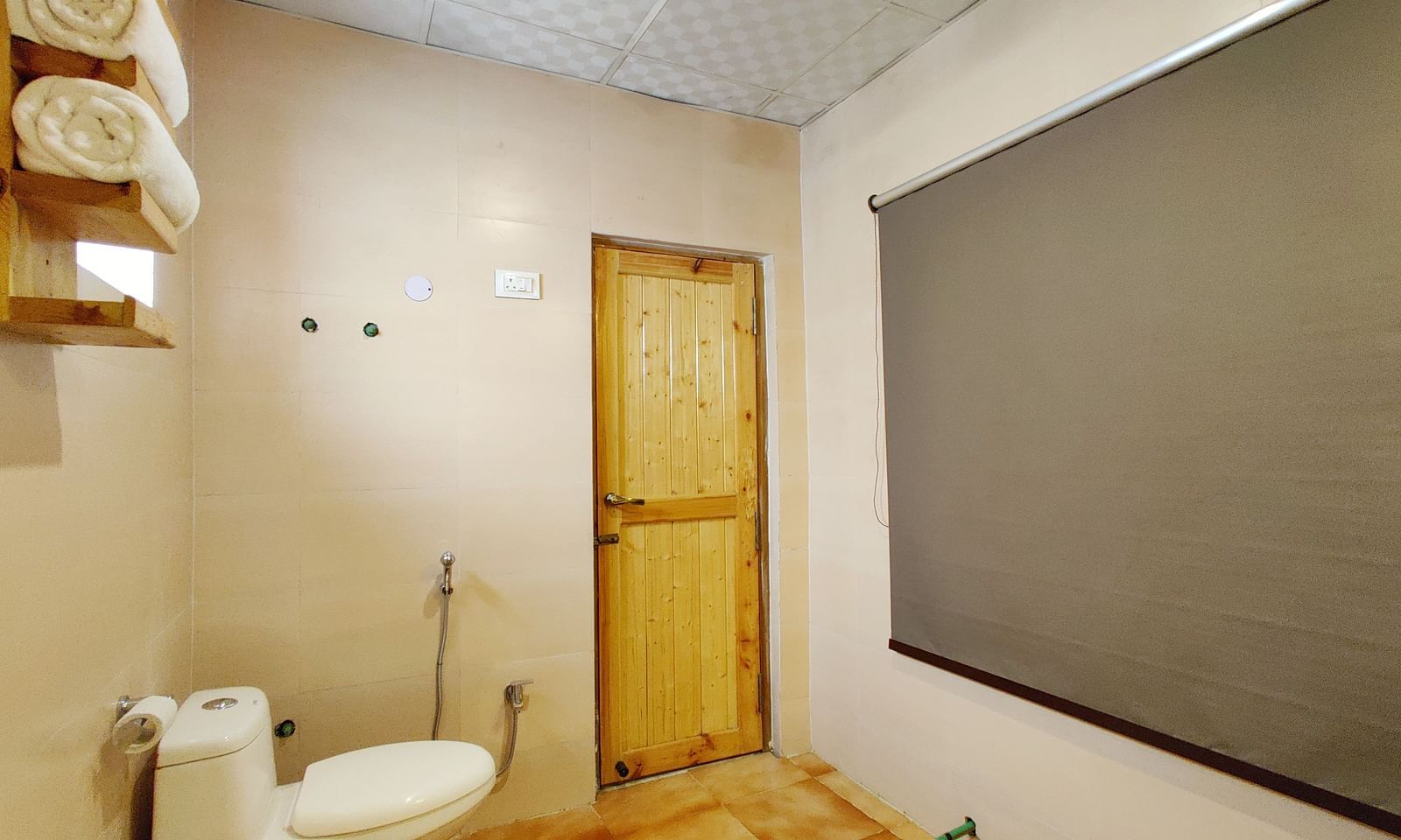 A bathroom in Premium Cottage at White Sands Resort, Ladakh, is equipped with a toilet, sink, and shower.
