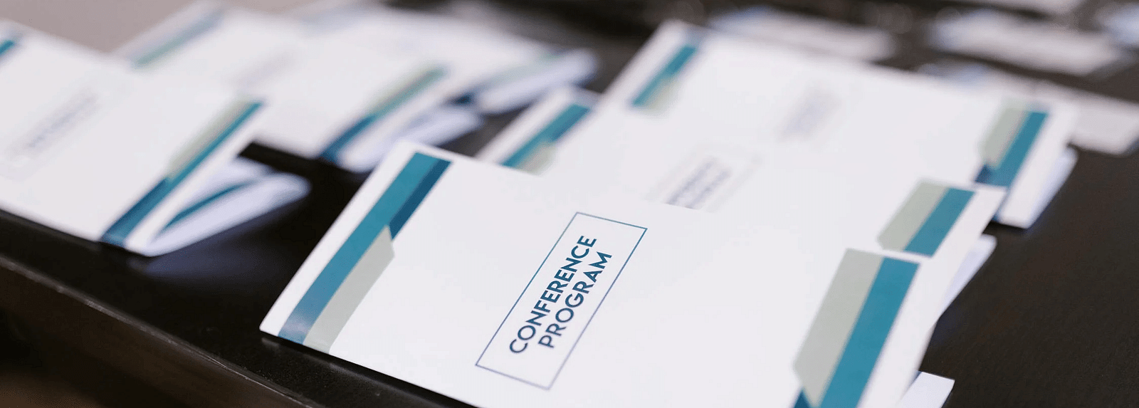 Side view of a table with brochures neatly laid out on top.